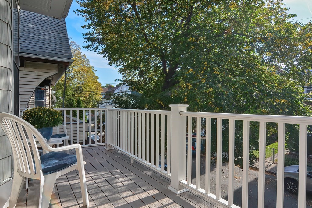 17-19 Walnut Road Somerville, MA 02145 - Photo 23 of 42 a balcony with wooden floor and fence