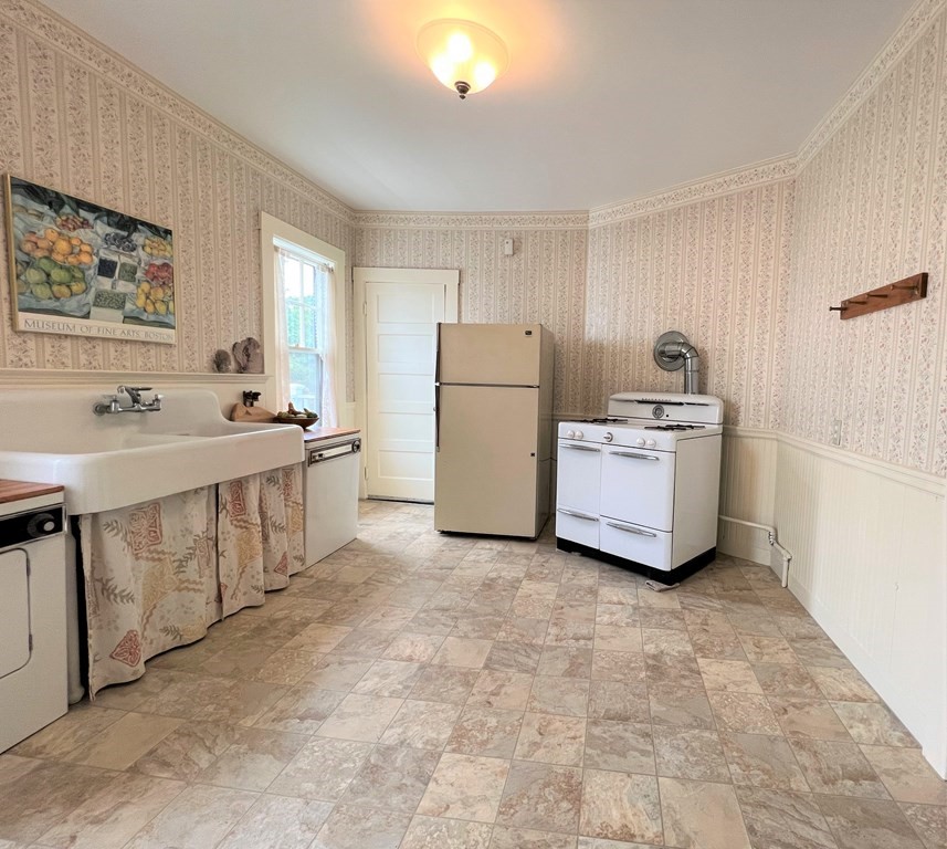 17-19 Walnut Road Somerville, MA 02145 - Photo 29 of 42 a kitchen with a sink stove and refrigerator