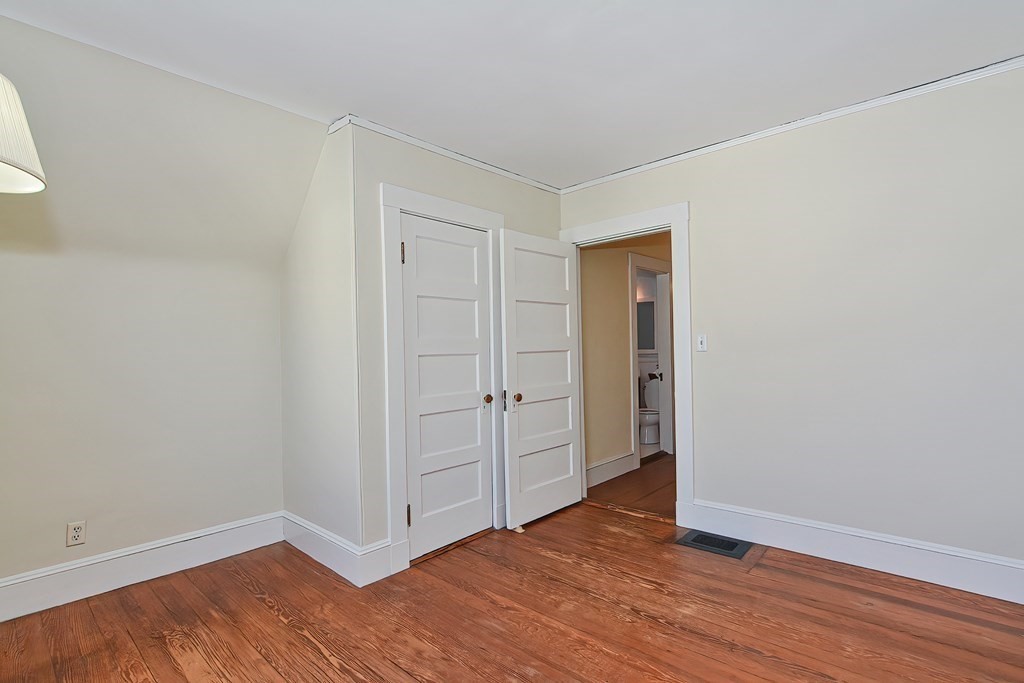 17-19 Walnut Road Somerville, MA 02145 - Photo 34 of 42 a view of an empty room with wooden floor