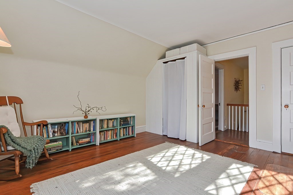 17-19 Walnut Road Somerville, MA 02145 - Photo 38 of 42 a view of a bedroom with furniture and staircase