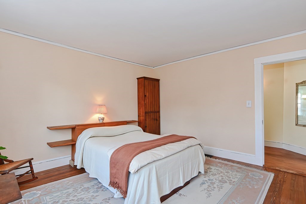 17-19 Walnut Road Somerville, MA 02145 - Photo 40 of 42 a bedroom with a bed and wooden floor