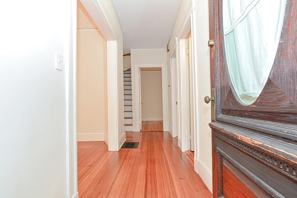 17-19 Walnut Road Somerville, MA 02145 - Photo 5 of 42 a view of a hallway with wooden floor and staircase