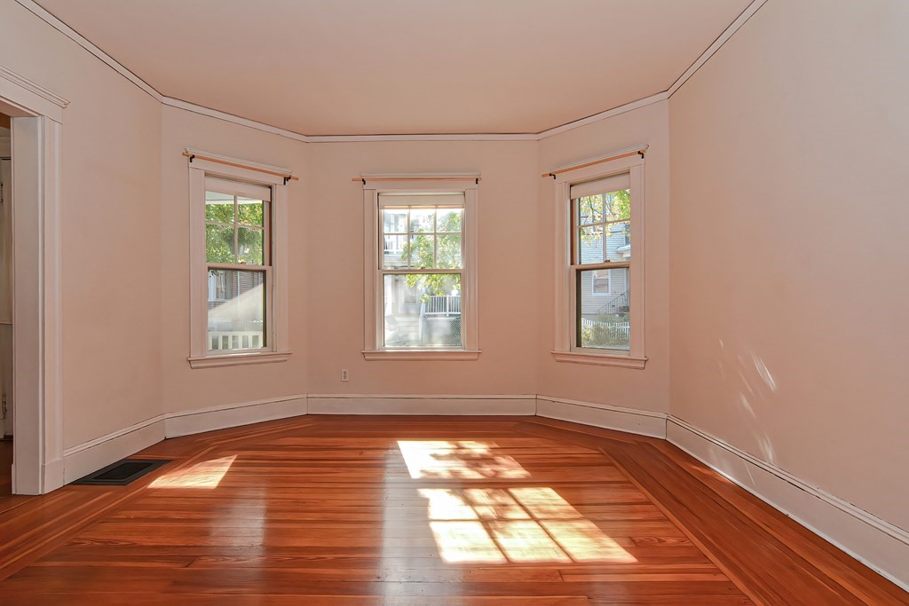 17-19 Walnut Road Somerville, MA 02145 - Photo 6 of 42 a view of empty room with wooden floor and fan
