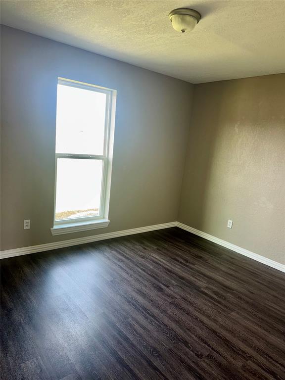 136 Chris Court Alvarado, TX 76009 - Photo 6 of 9 an empty room with wooden floor and windows