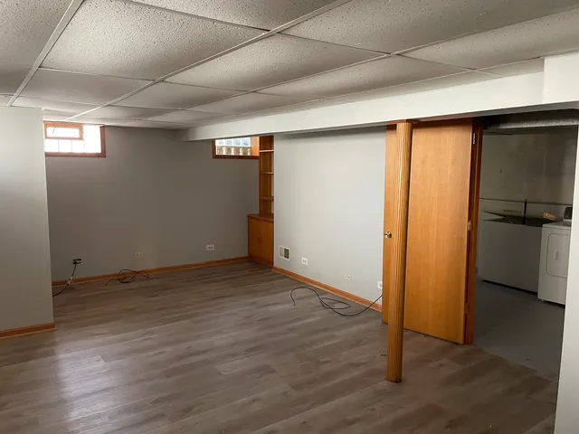 an empty room with wooden floor door and closet