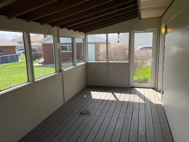 a view of a porch with wooden floor and outdoor space