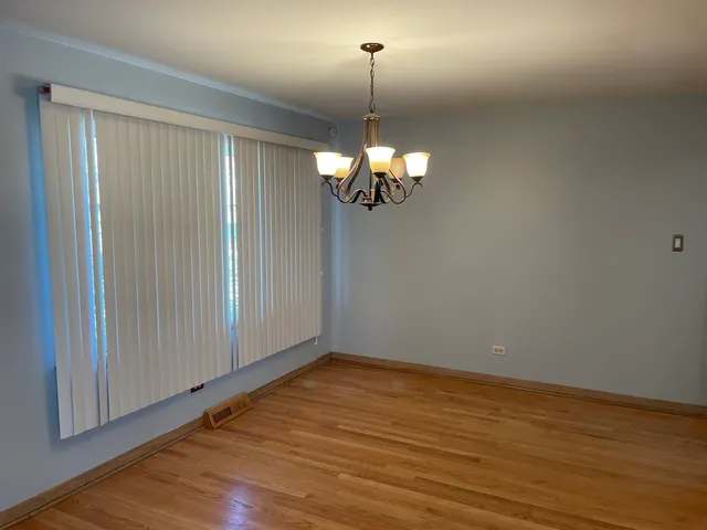 a view of a room with wooden floor fan and window