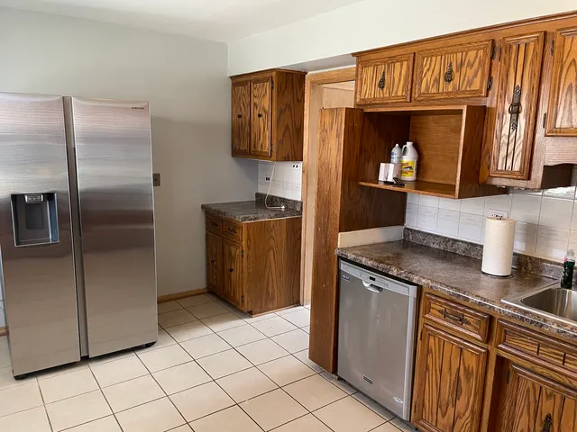 a kitchen with stainless steel appliances granite countertop a refrigerator and a stove