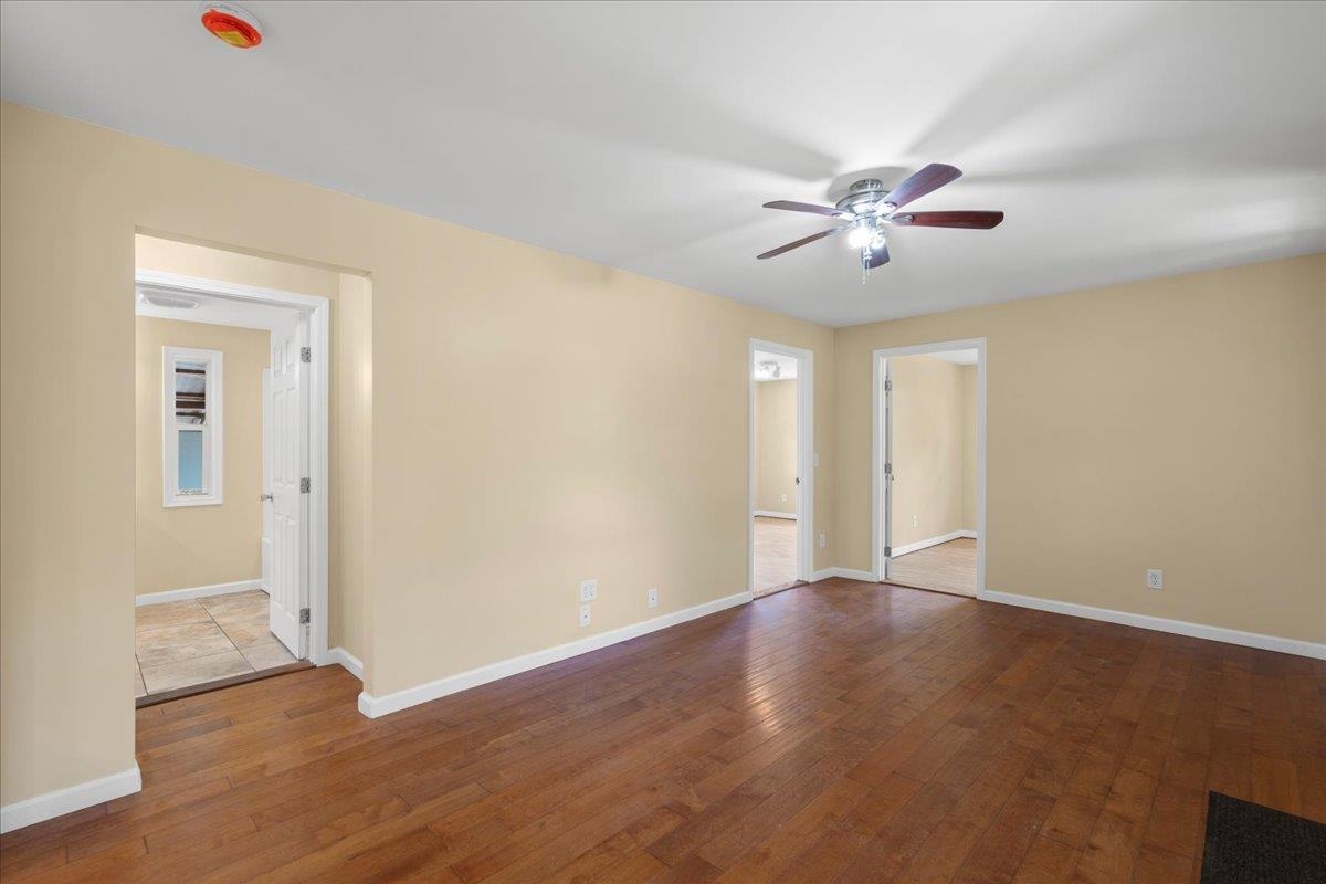 752 Noholani Street Haiku, HI 96708 - Photo 16 of 45 an empty room with wooden floor and ceiling fan