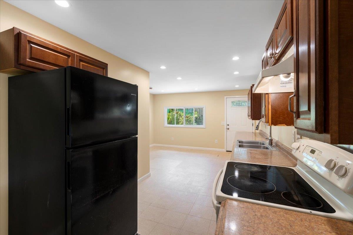 752 Noholani Street Haiku, HI 96708 - Photo 18 of 45 a kitchen with a refrigerator and a sink