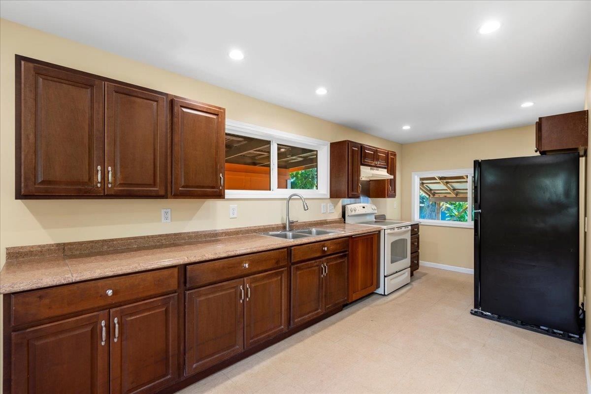 752 Noholani Street Haiku, HI 96708 - Photo 19 of 45 a kitchen with stainless steel appliances granite countertop a refrigerator and a sink