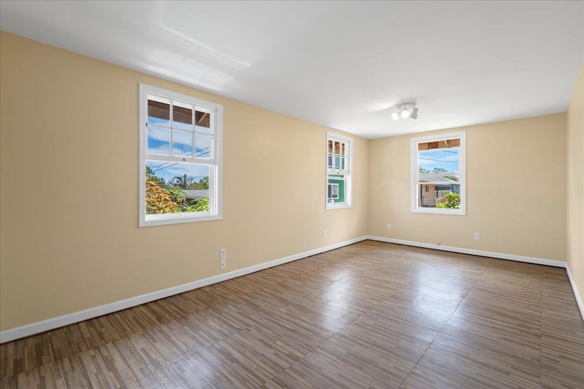 752 Noholani Street Haiku, HI 96708 - Photo 24 of 45 a view of an empty room with wooden floor and a window