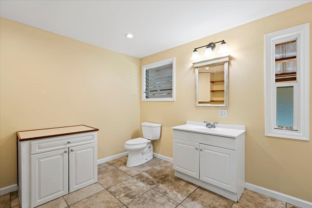 752 Noholani Street Haiku, HI 96708 - Photo 29 of 45 a room with a toilet a sink and a window