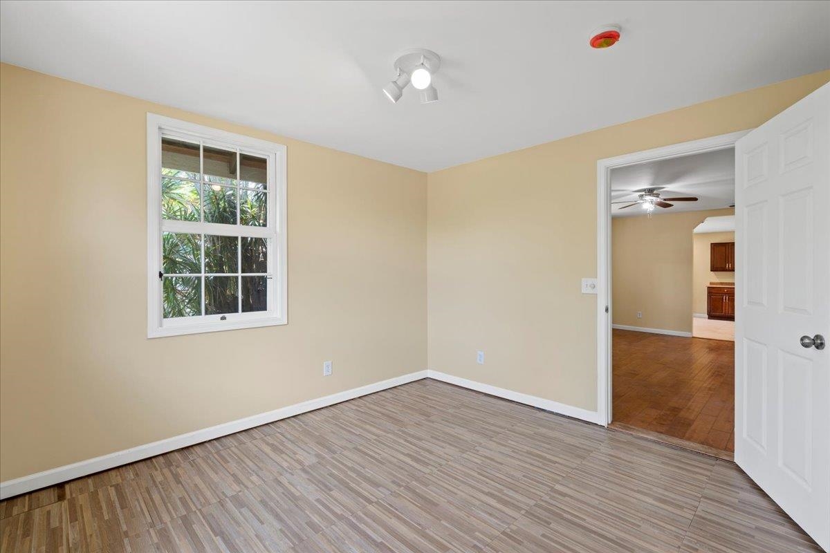 752 Noholani Street Haiku, HI 96708 - Photo 32 of 45 a view of an empty room with wooden floor and a window