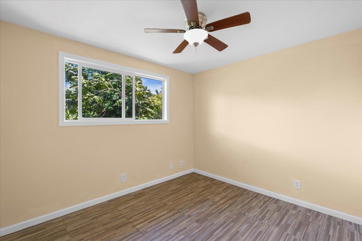 752 Noholani Street Haiku, HI 96708 - Photo 35 of 45 an empty room with wooden floor and windows