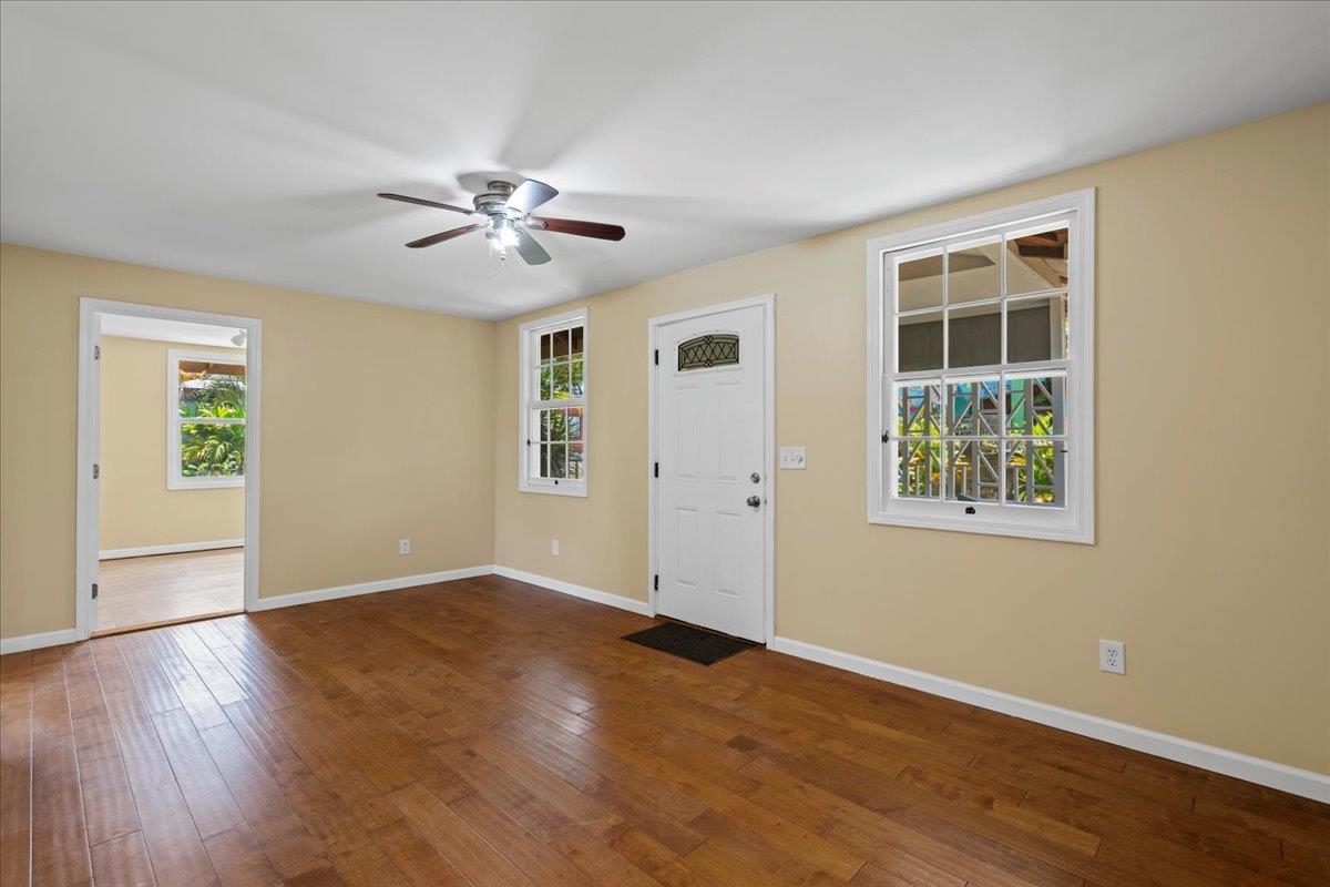 752 Noholani Street Haiku, HI 96708 - Photo 4 of 45 a view of an empty room with wooden floor and a window