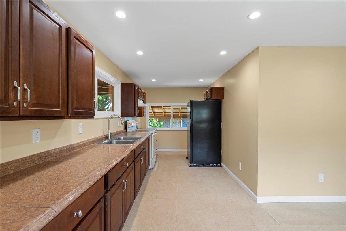 752 Noholani Street Haiku, HI 96708 - Photo 8 of 45 a kitchen with stainless steel appliances granite countertop a sink and cabinets