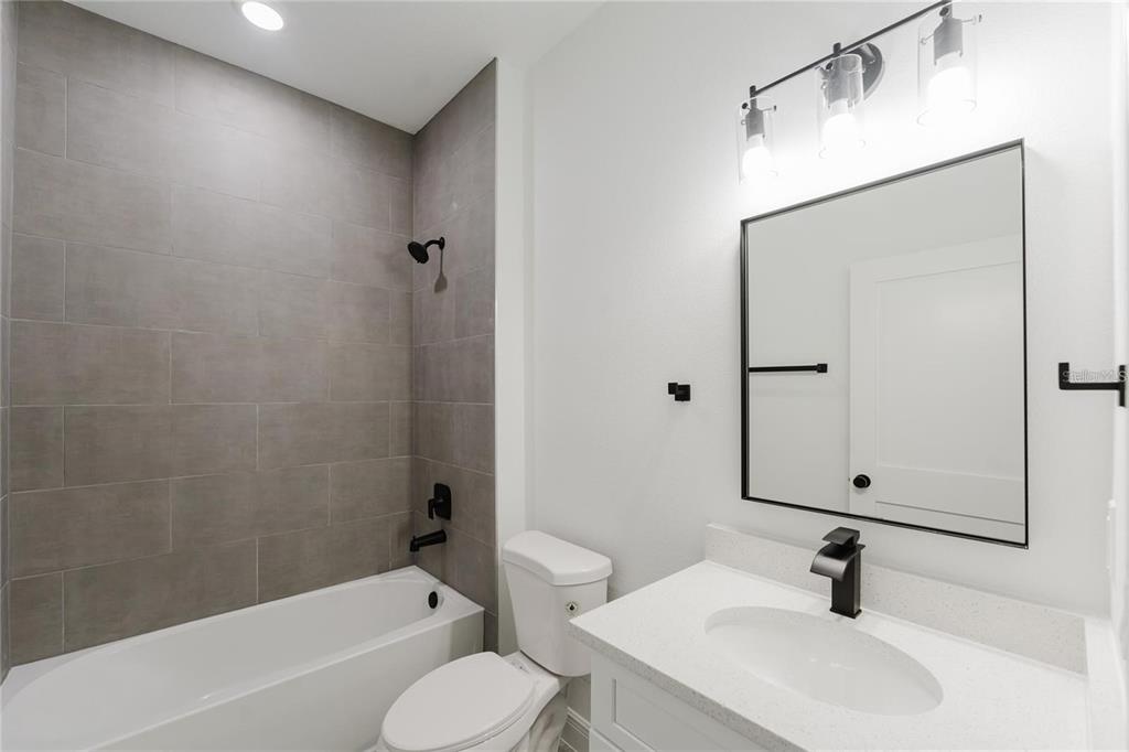 6732 Southwest 132nd Street Ocala, FL 34473 - Photo 21 of 36 a bathroom with a sink toilet a mirror and shower