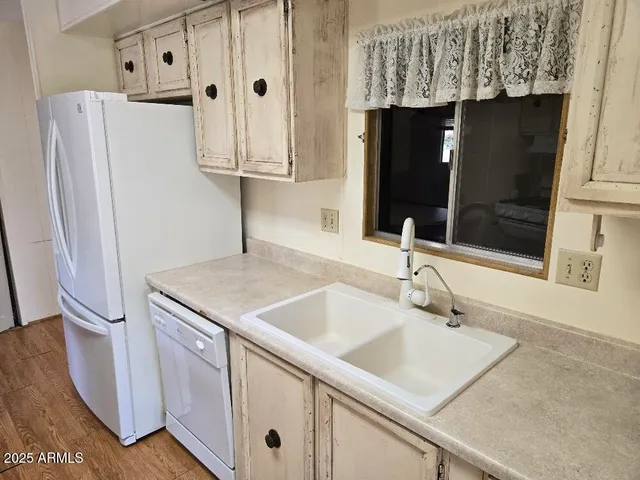 a kitchen with a sink and a refrigerator