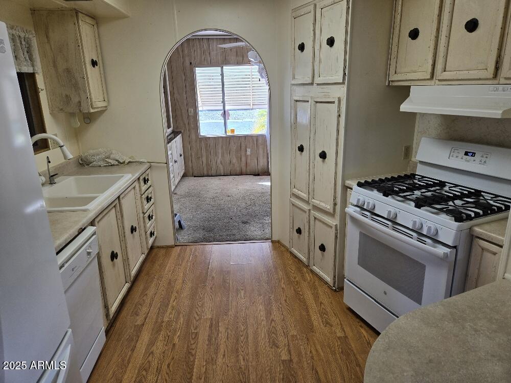 19065 North Dinero Road Sun City, AZ 85373 - Photo 18 of 37 a kitchen with stainless steel appliances a stove sink and refrigerator