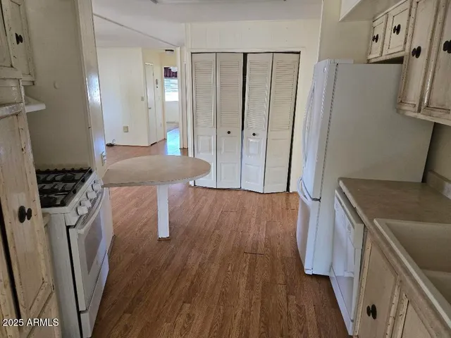 a kitchen with a wooden floor and a stove top oven