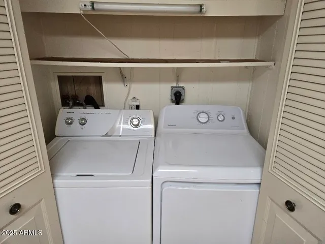 a view of a room with wooden floor and a window