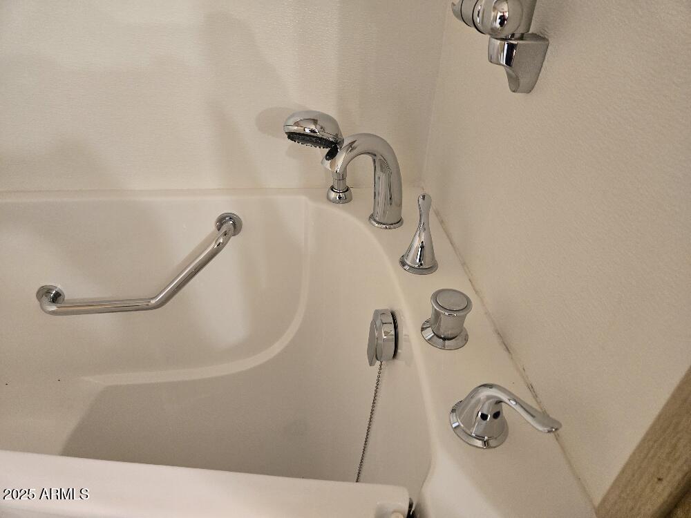 19065 North Dinero Road Sun City, AZ 85373 - Photo 32 of 37 a bathroom with a shower