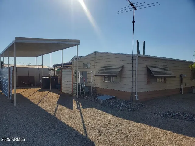 a wooden bench sitting in front of a building