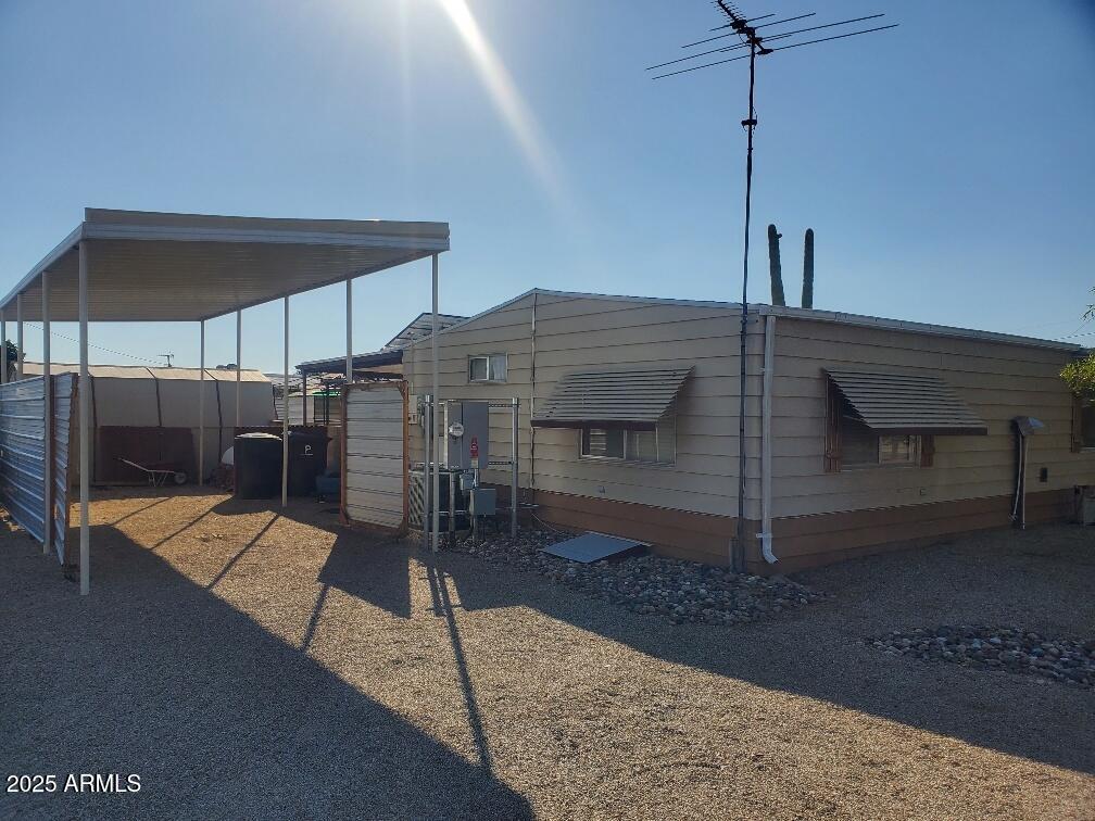 19065 North Dinero Road Sun City, AZ 85373 - Photo 6 of 37 a wooden bench sitting in front of a building
