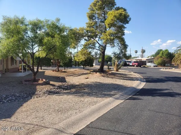 a view of road with card parked on side and road