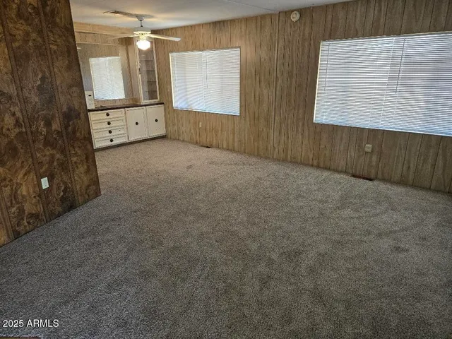 en empty room with windows and cabinet