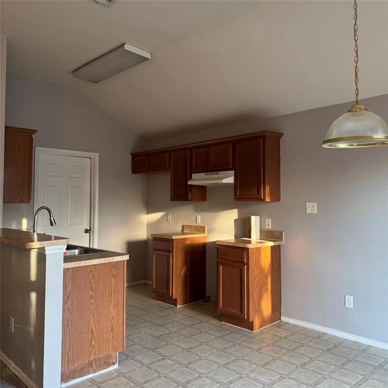 12320 Fish Road Dallas, TX 75253 - Photo 4 of 11 a kitchen with kitchen island stainless steel appliances a sink stove and refrigerator