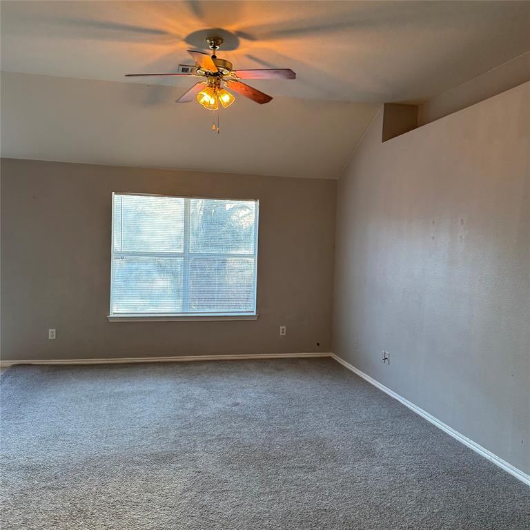 12320 Fish Road Dallas, TX 75253 - Photo 5 of 11 an empty room with a window and a fan