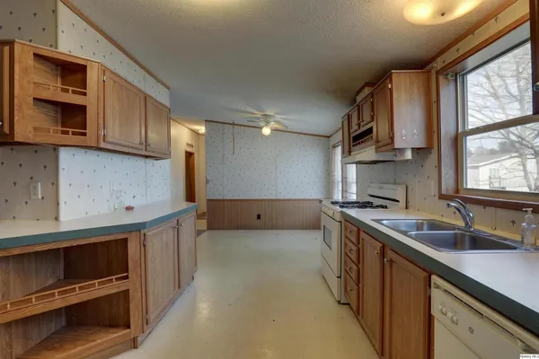 a kitchen with stainless steel appliances a sink stove and cabinets