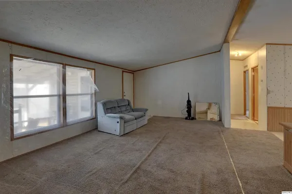 a living room with furniture and a floor to ceiling window