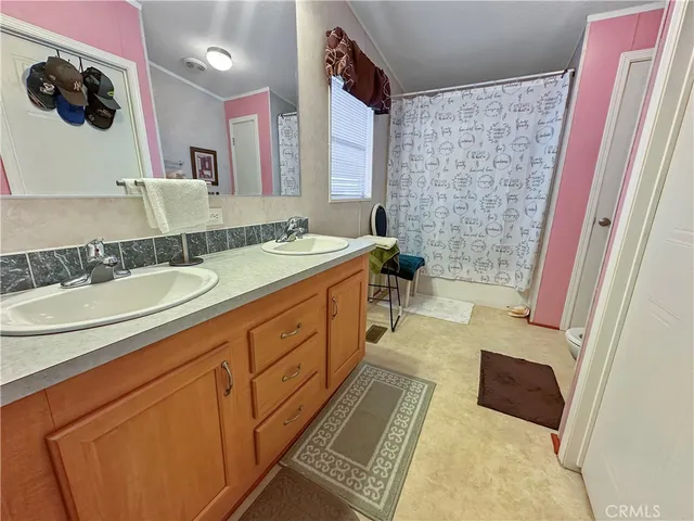 a spacious bathroom with a tub sink and mirror