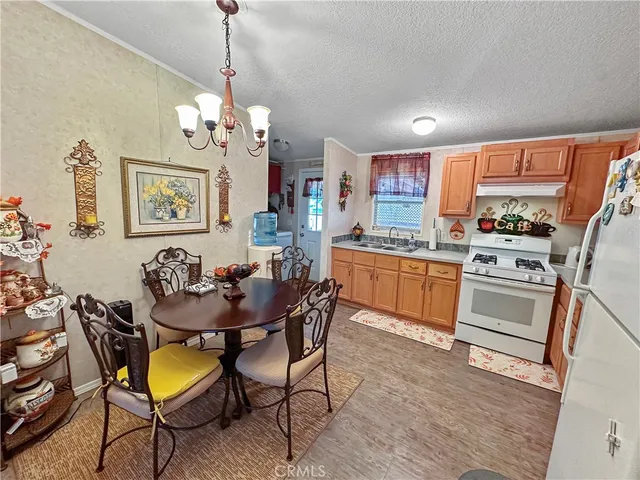 a view of a dining room with furniture and chandelier
