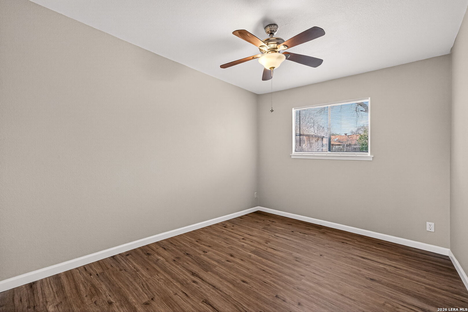 301 Deborah Drive Converse, TX 78109 - Photo 20 of 27 an empty room with wooden floor and ceiling fan