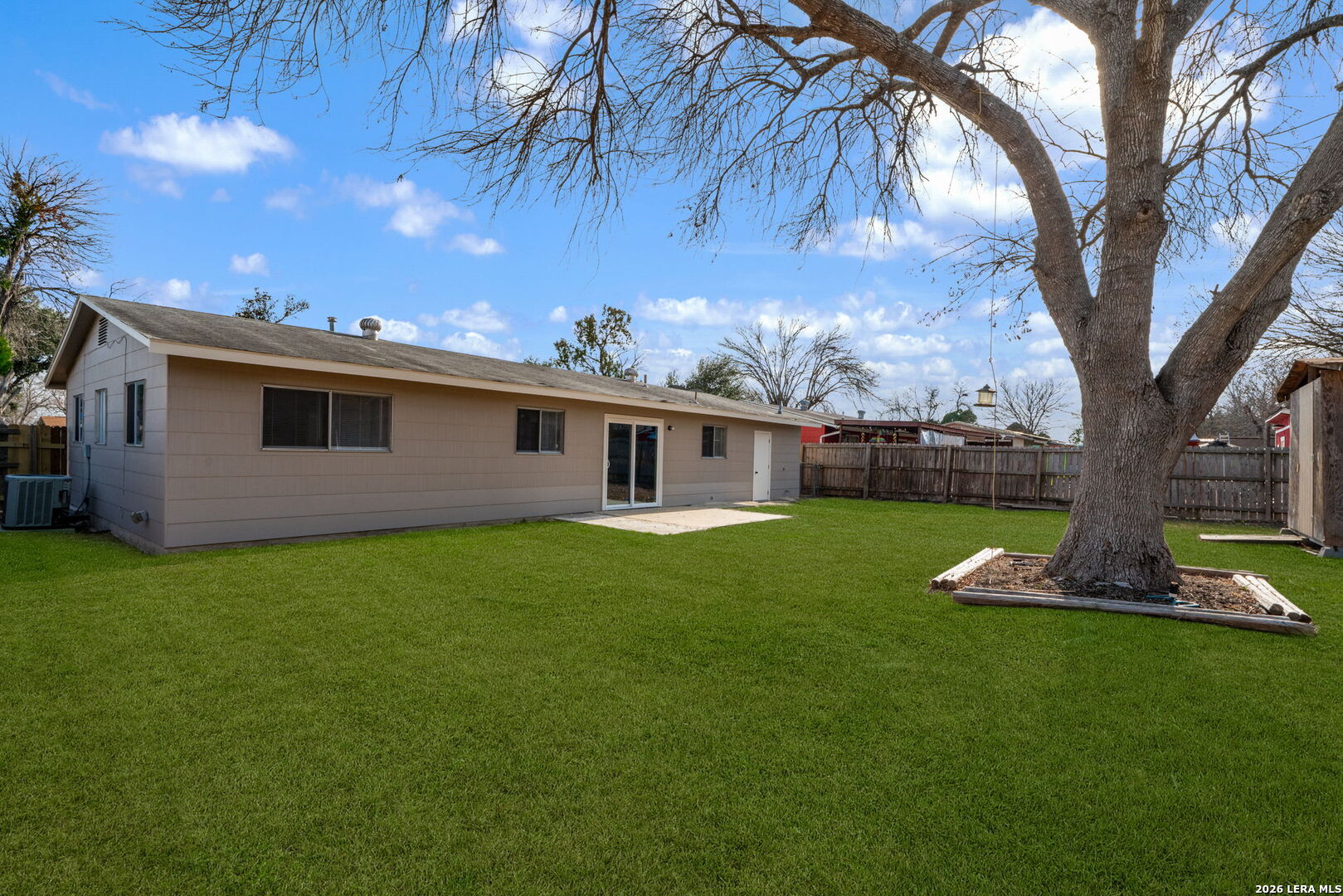 301 Deborah Drive Converse, TX 78109 - Photo 5 of 27 a backyard of a house with plants and large tree