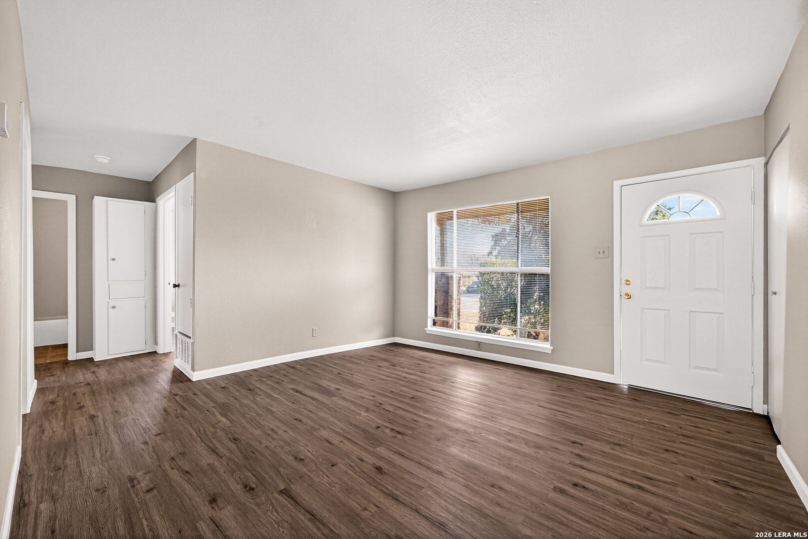301 Deborah Drive Converse, TX 78109 - Photo 6 of 27 a view of an empty room with wooden floor and a window