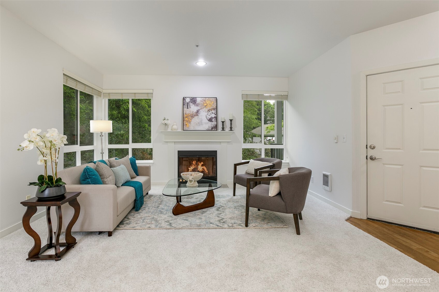a living room with furniture and a fireplace