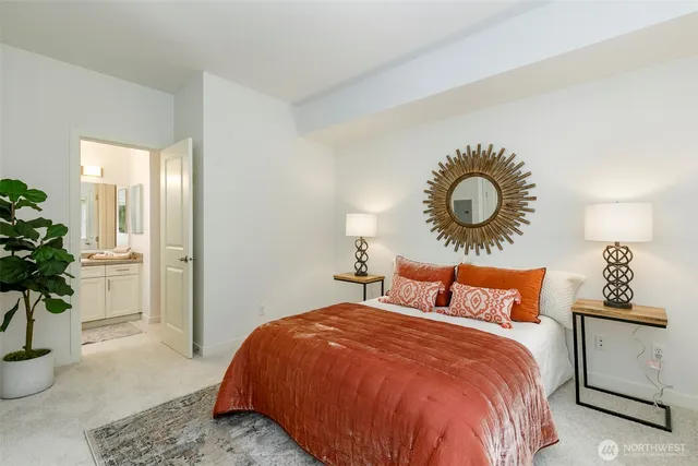 a bedroom with a bed and a potted plant