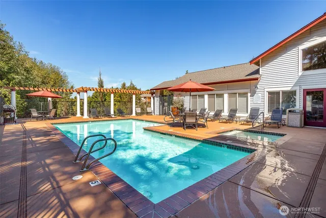 a view of a swimming pool with lounge chairs