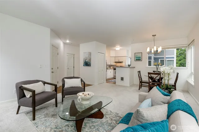 a living room with furniture and kitchen view