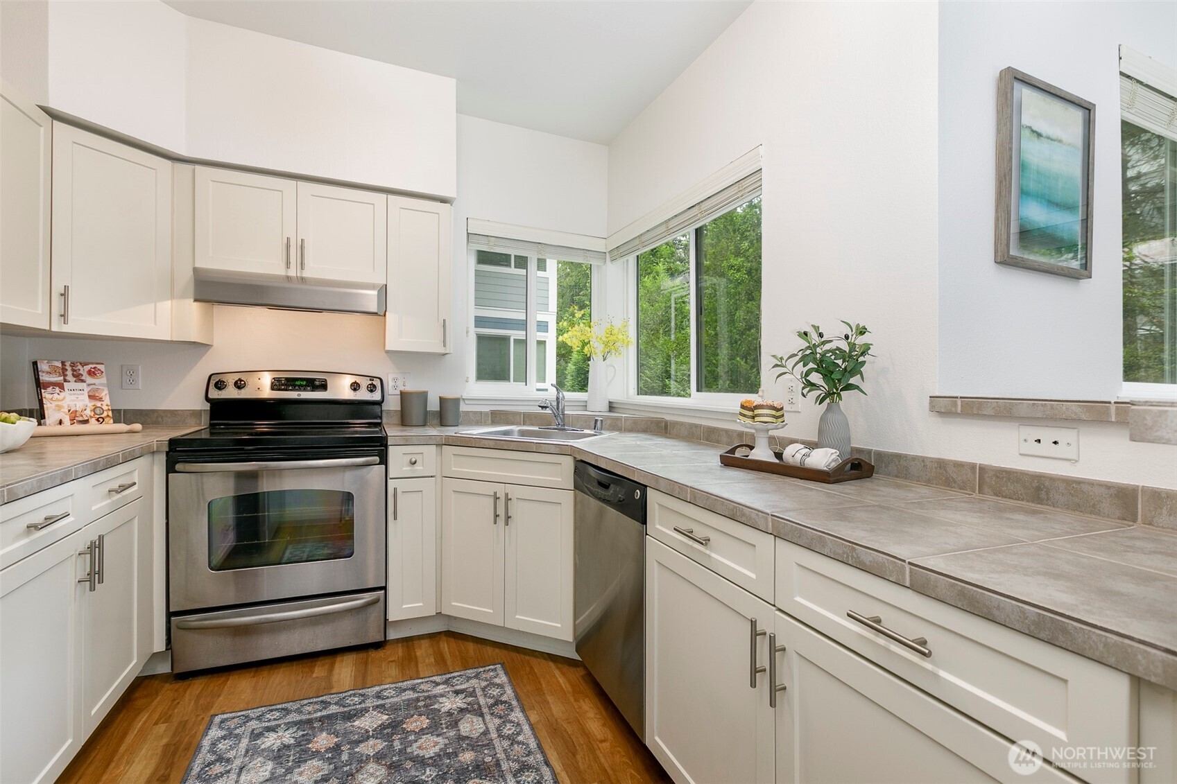 3915 243rd Place Southeast, Unit K204 Bothell, WA 98021 - Photo 10 of 23 a kitchen with a sink stove and microwave