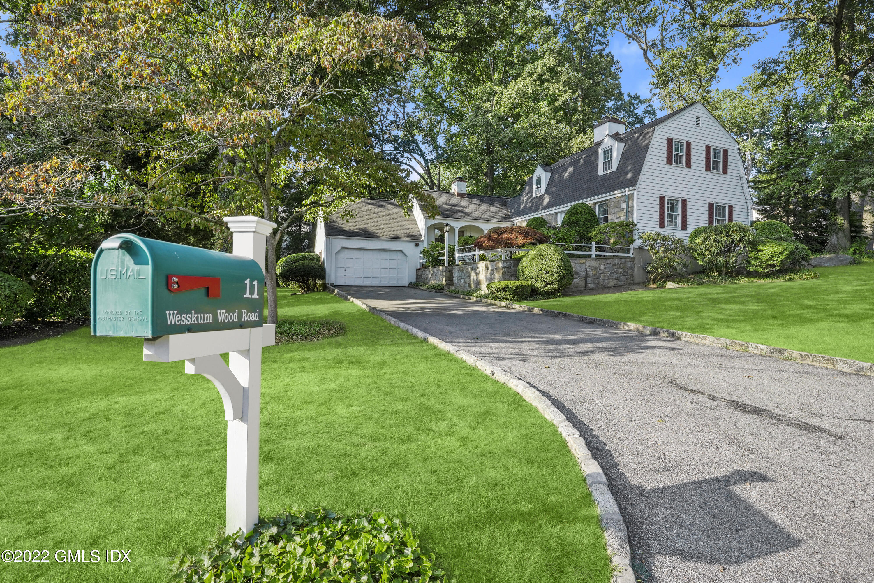 11 Wesskum Wood Road Riverside, CT 06878 - Photo 1 of 17 a front view of a house with a yard and tree