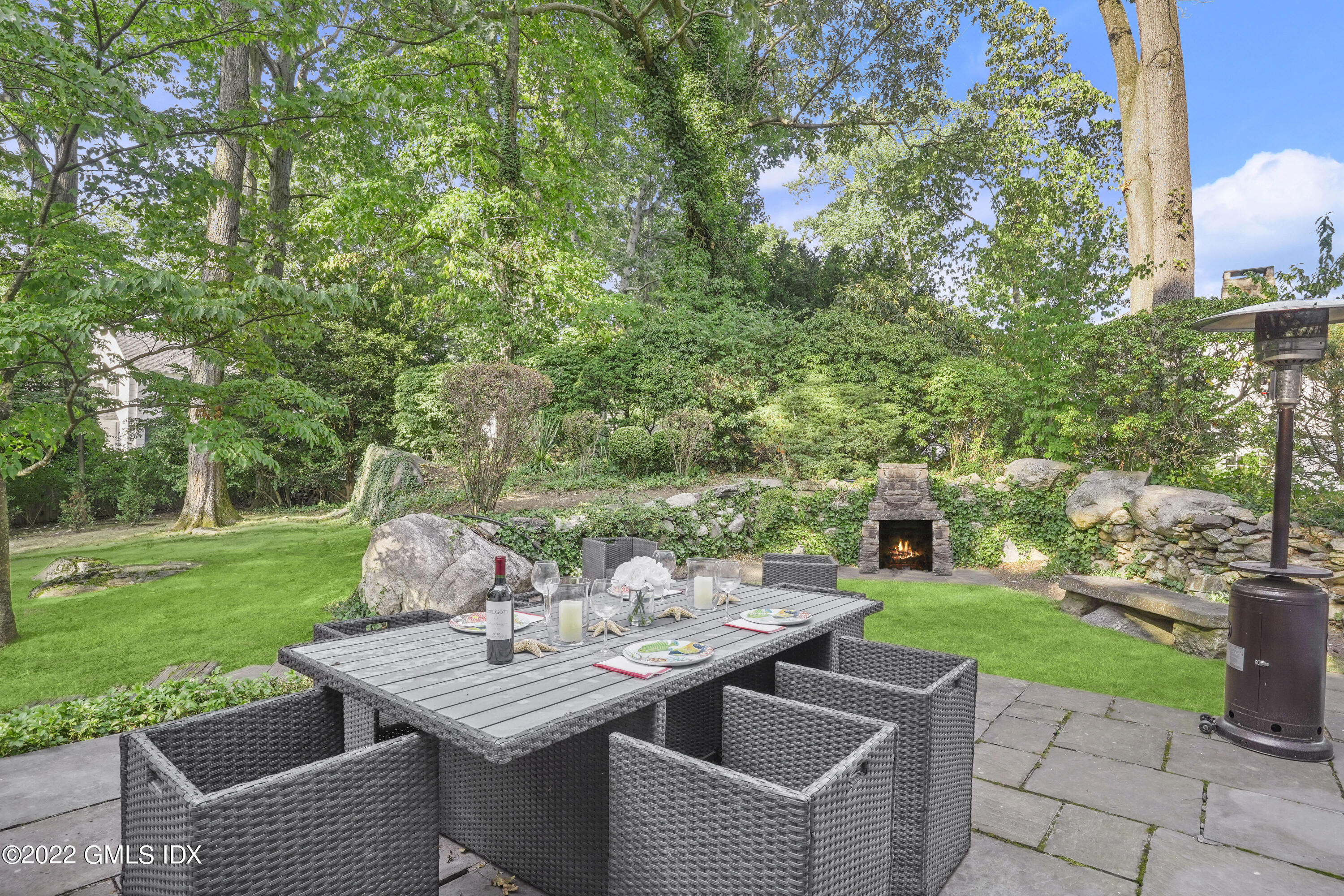 11 Wesskum Wood Road Riverside, CT 06878 - Photo 13 of 17 a view of a patio with table and chairs potted plants and a large tree