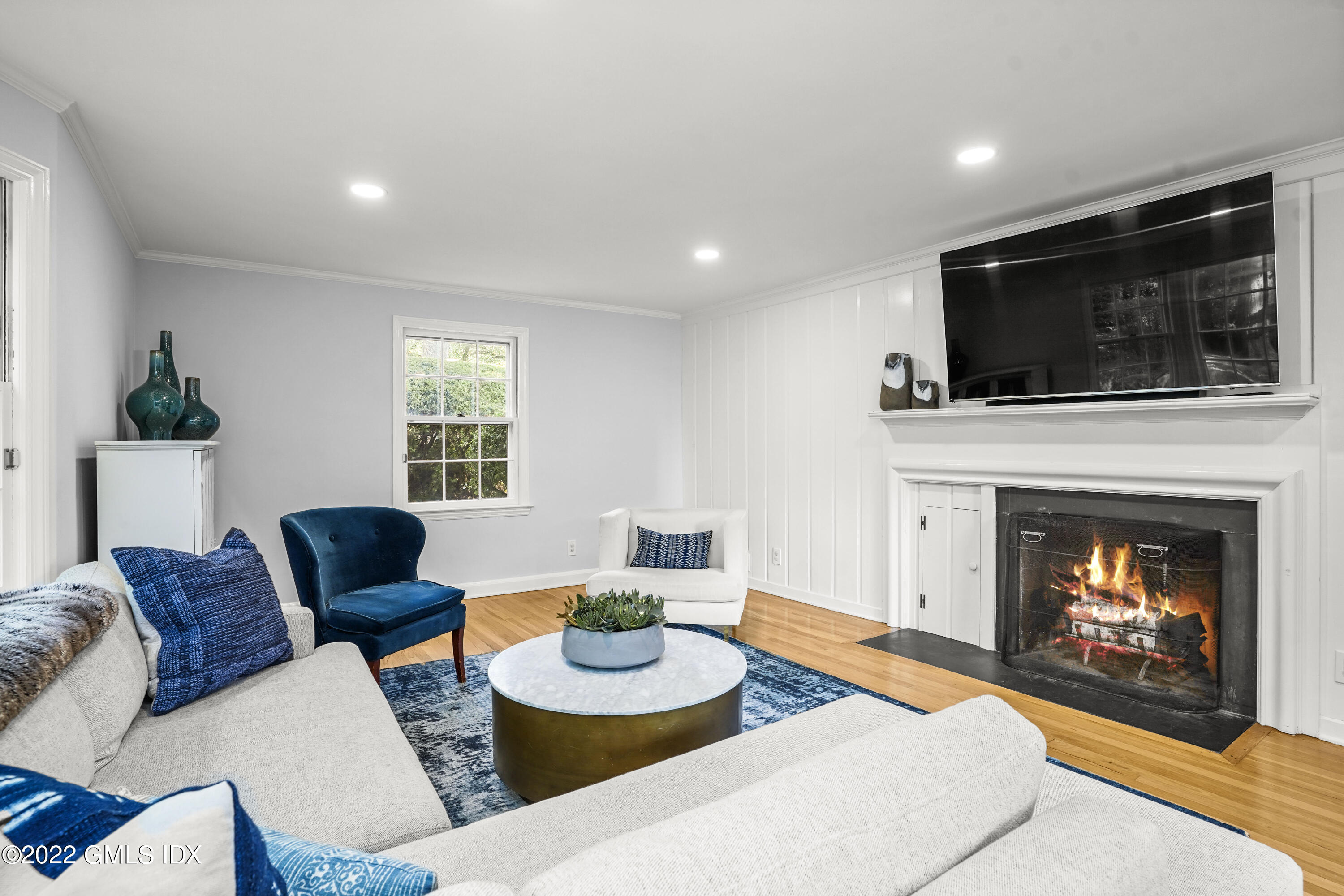 11 Wesskum Wood Road Riverside, CT 06878 - Photo 2 of 17 a living room with furniture a flat screen tv and a fireplace