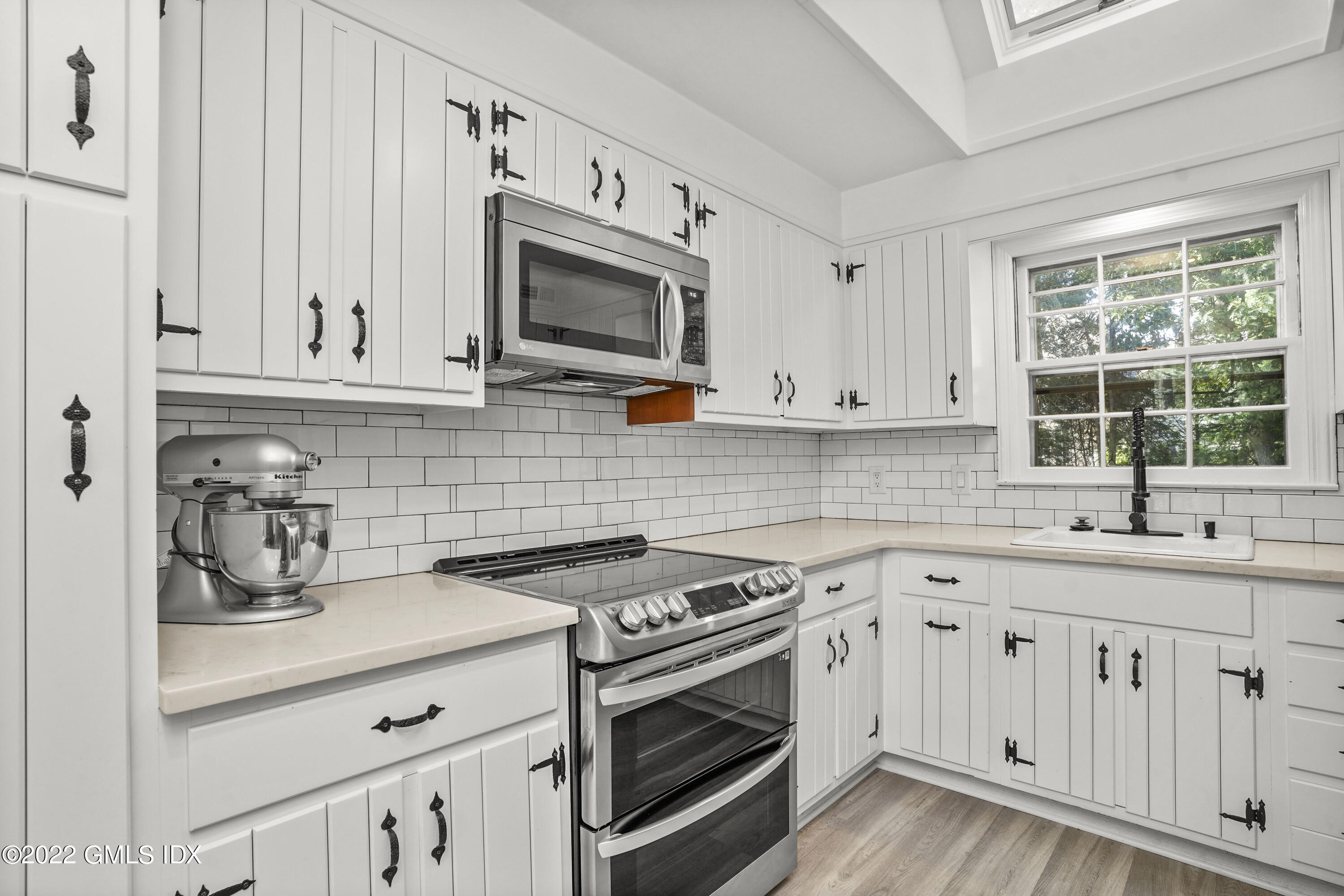 11 Wesskum Wood Road Riverside, CT 06878 - Photo 5 of 17 a kitchen with white cabinets and appliances