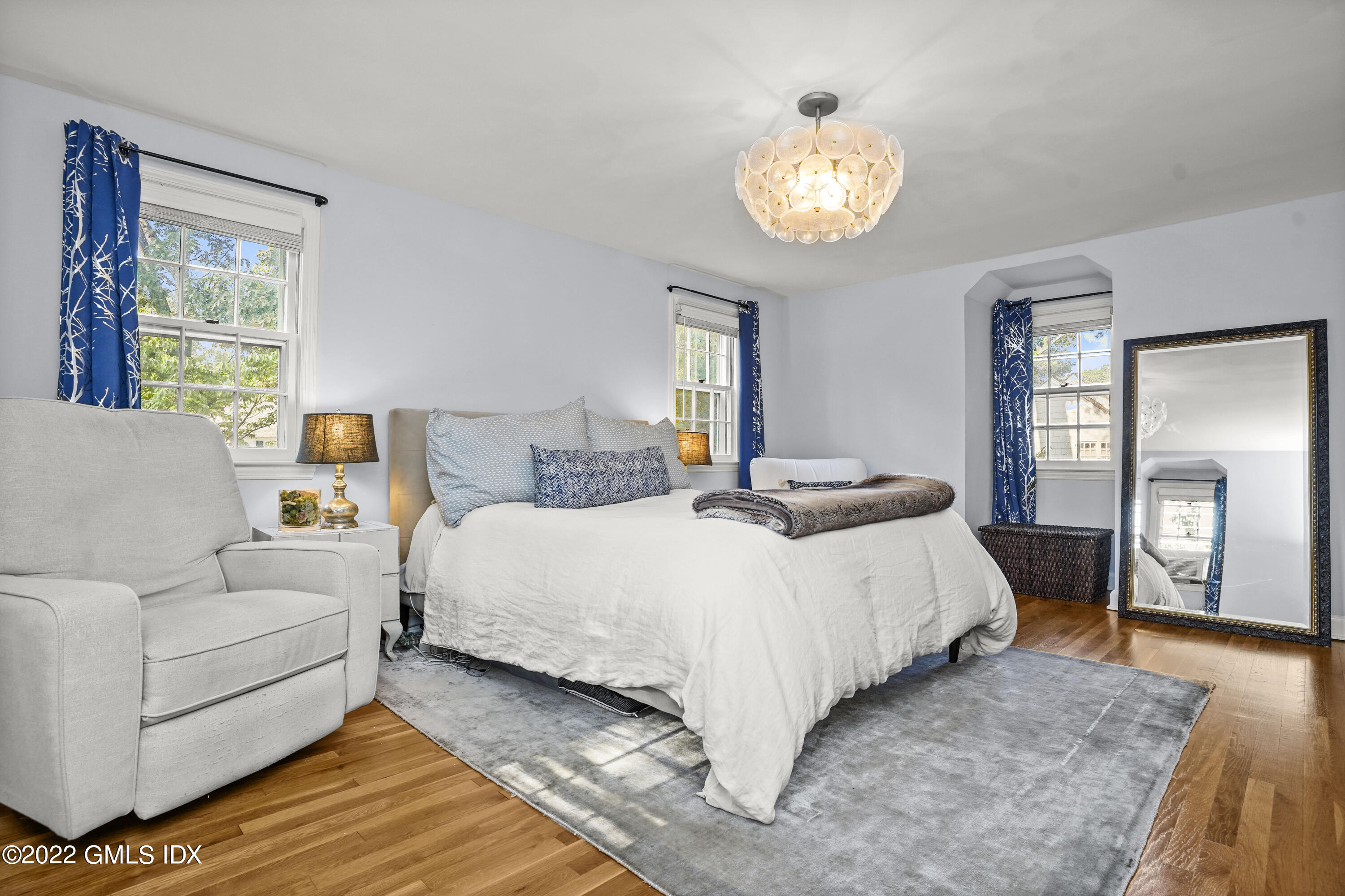 11 Wesskum Wood Road Riverside, CT 06878 - Photo 7 of 17 a bedroom with a bed and a chandelier